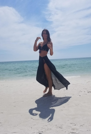 Reviewer wearing black swimsuit coverup