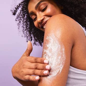 A model rubbing the cream into their arm