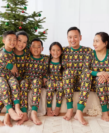 a family in matching pikachu holiday pajamas