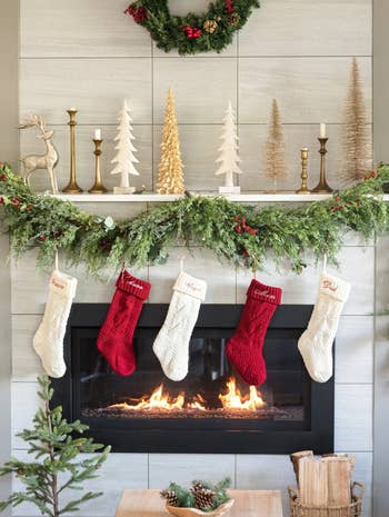 five of the red and cream stockings hung over a fireplace