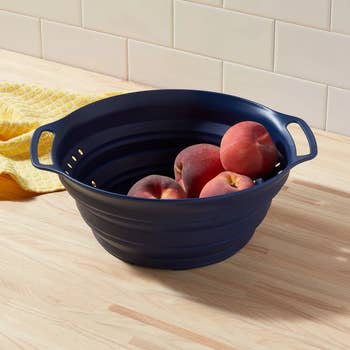 Image of blue colander with fruit in it