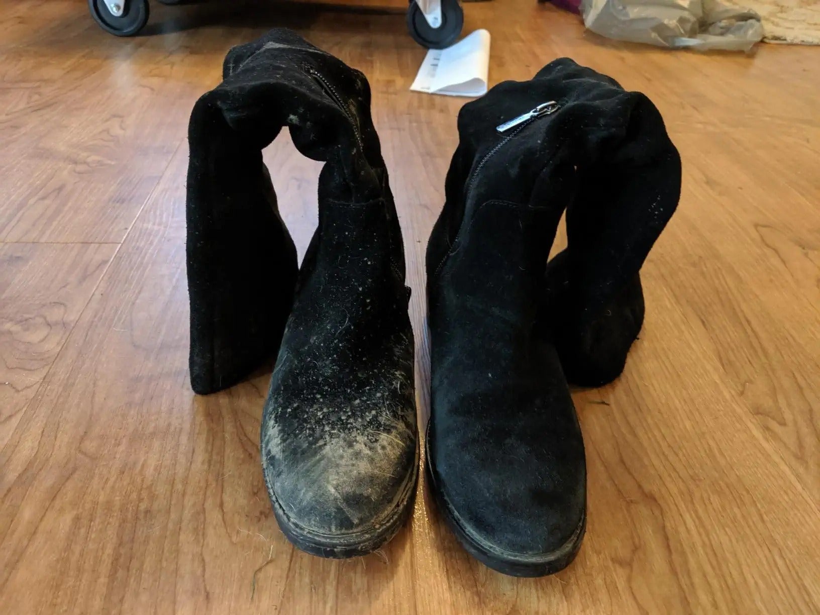 two suede boots, one covered in mud and one clean
