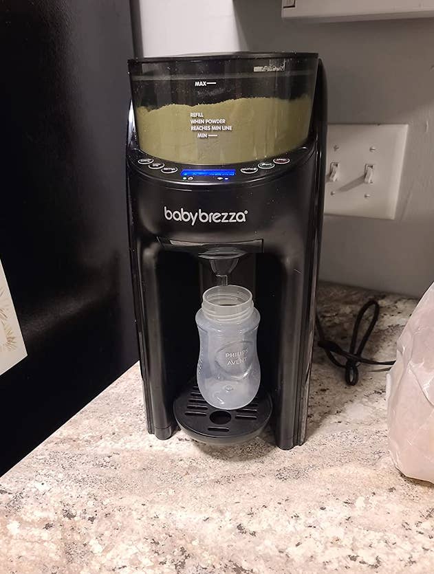 reviewer's dispenser making a baby bottle