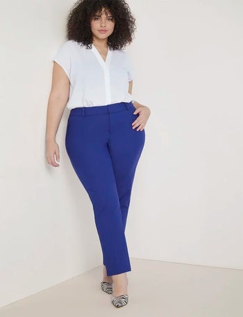 model wearing the blue pants with a white top