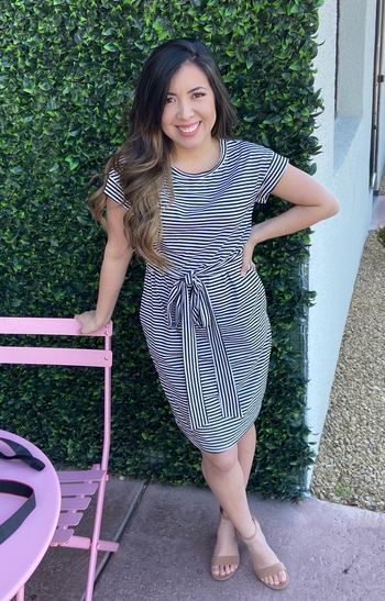 another reviewer wearing the black and white striped dress