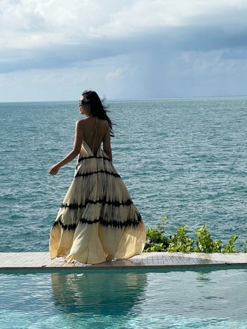 Model in a tie dye white and black maxi backless halter dress 