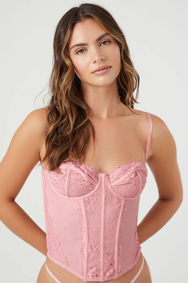 model posing wearing pink corset top