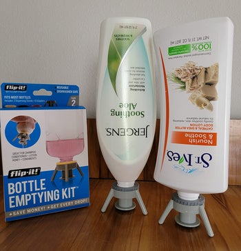reviewer's lotion bottles flipped upside down with gray stand caps