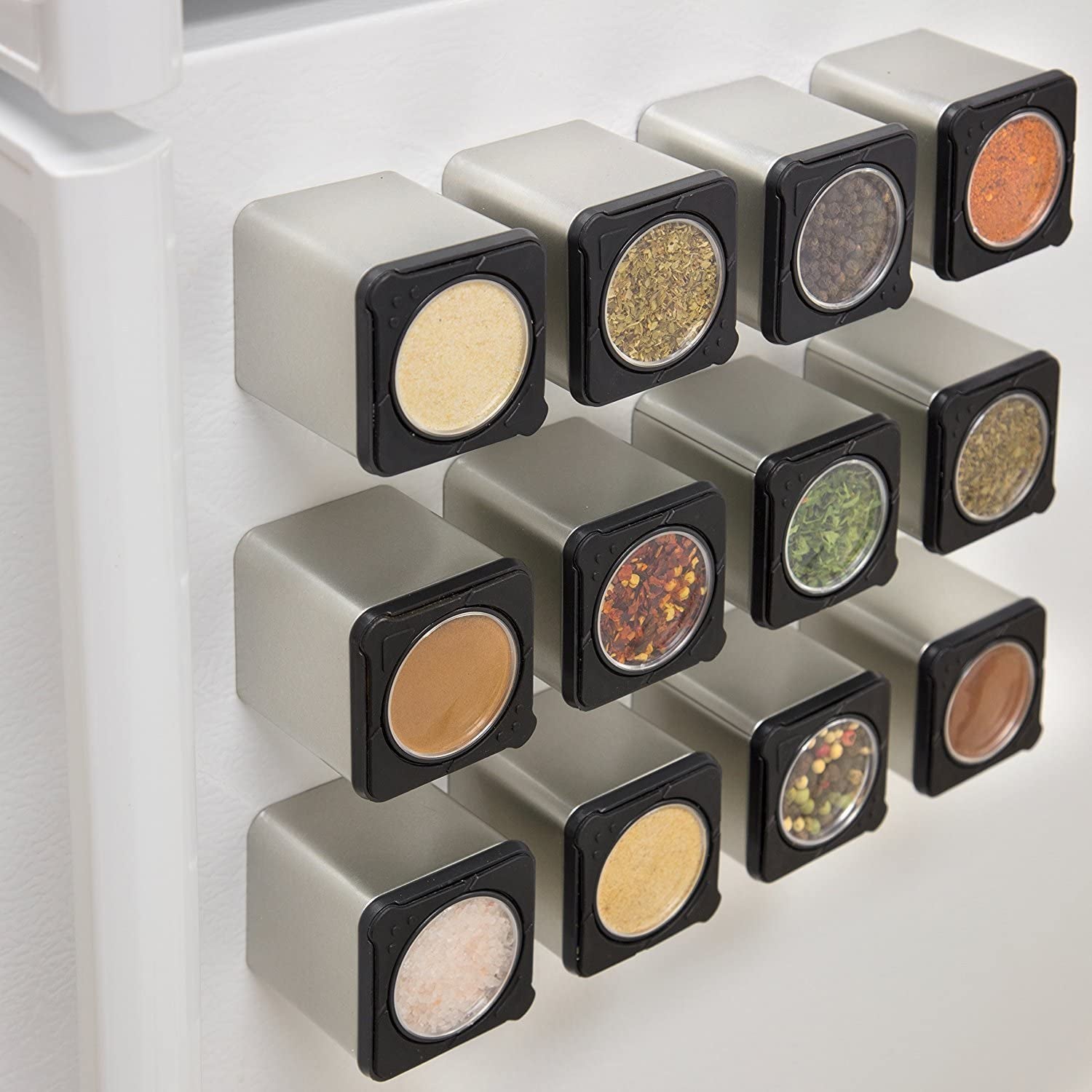 spice magnets filled with various spices and on display on a fridge