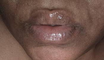 Close-up of a person's lips wearing glossy articulator balm