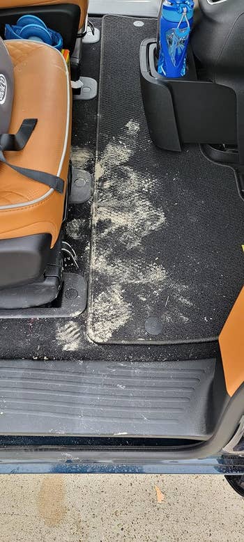 before of a reviewer's car floor covered in dust and crumbs