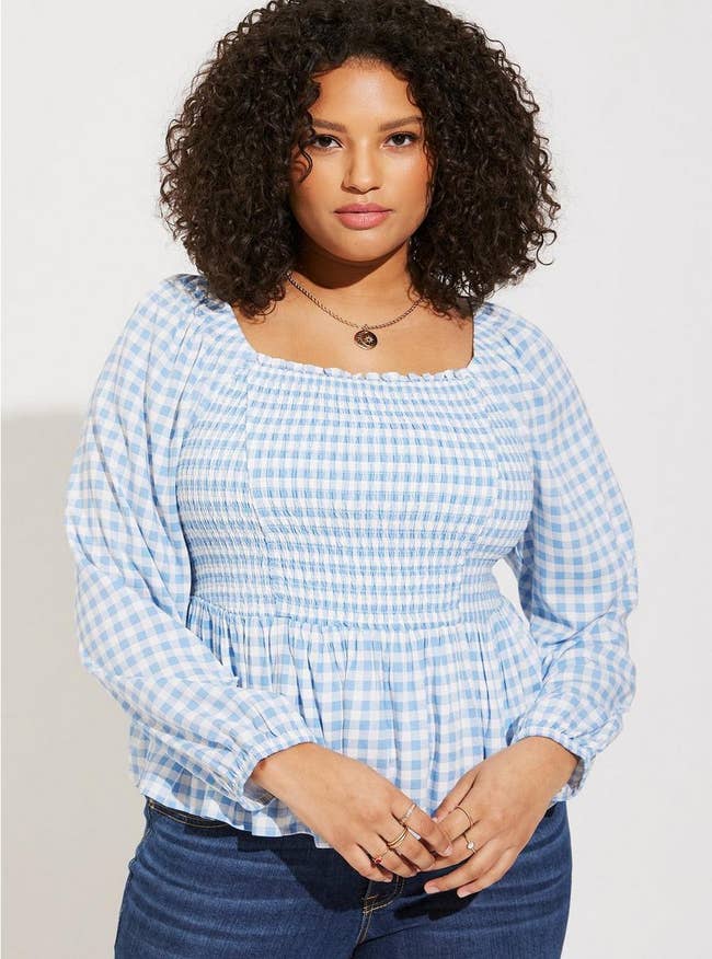 model wearing blue and white gingham blouse