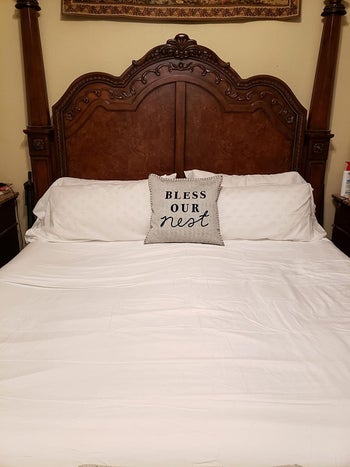 A reviewer's bed with the white sheets on it