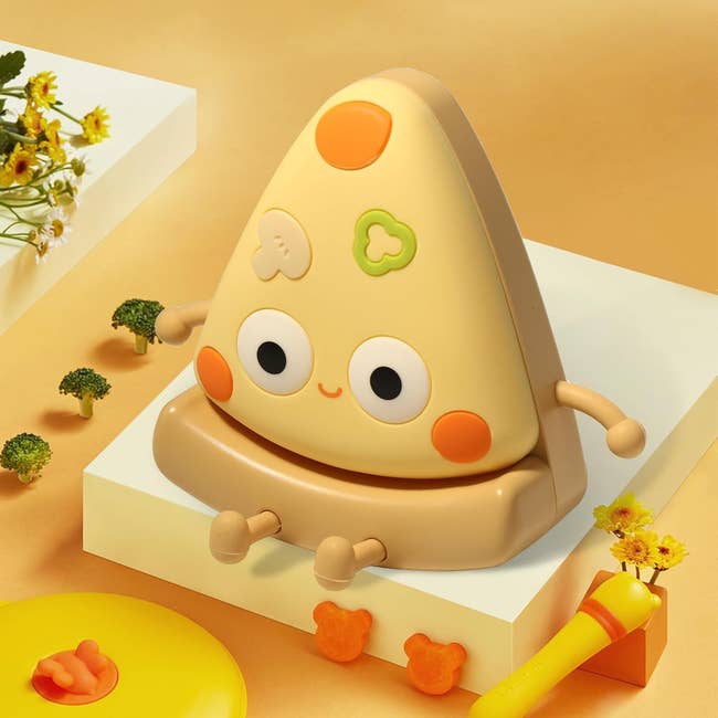 Illustration of a cute cartoon pizza-shaped night-light with a face, arms, and legs