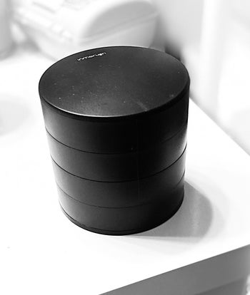 Reviewer image of product in black closed on top of white table