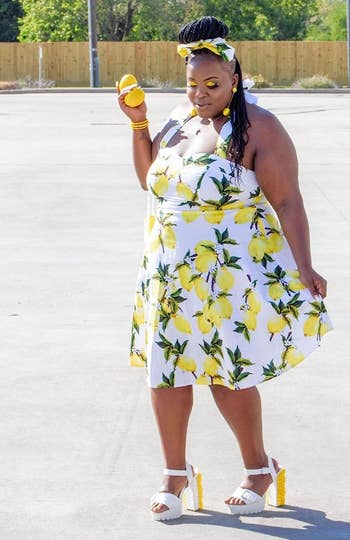 reviewer wearing the dress in a white and yellow lemon pattern