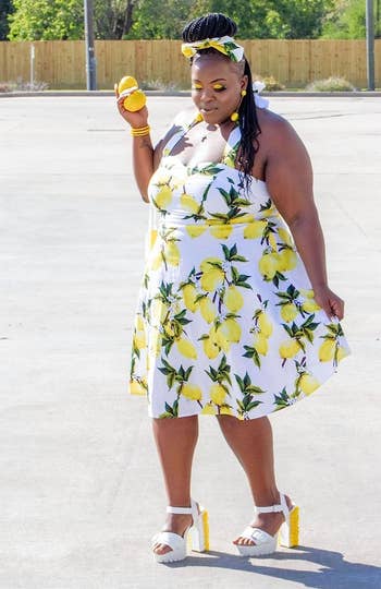 reviewer wearing the dress in a white and yellow lemon pattern
