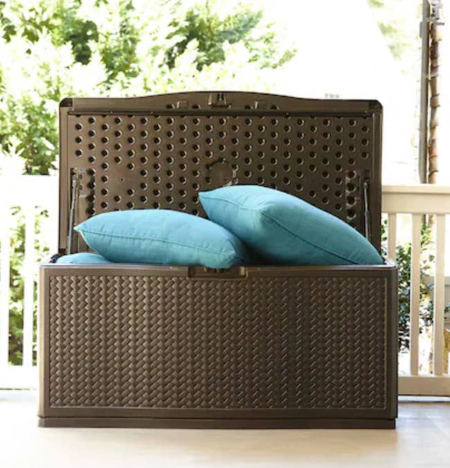 plastic deck storage container with pillows stored in it 