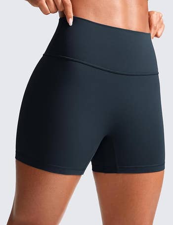 Person modeling high-waisted athletic shorts, showcasing a snug fit ideal for workouts