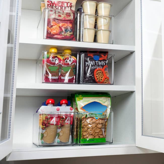 Shelves stocked with assorted snack items, including cookies, crackers, and candy