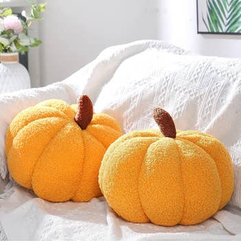 two orange pumpkin shaped throwpillows
