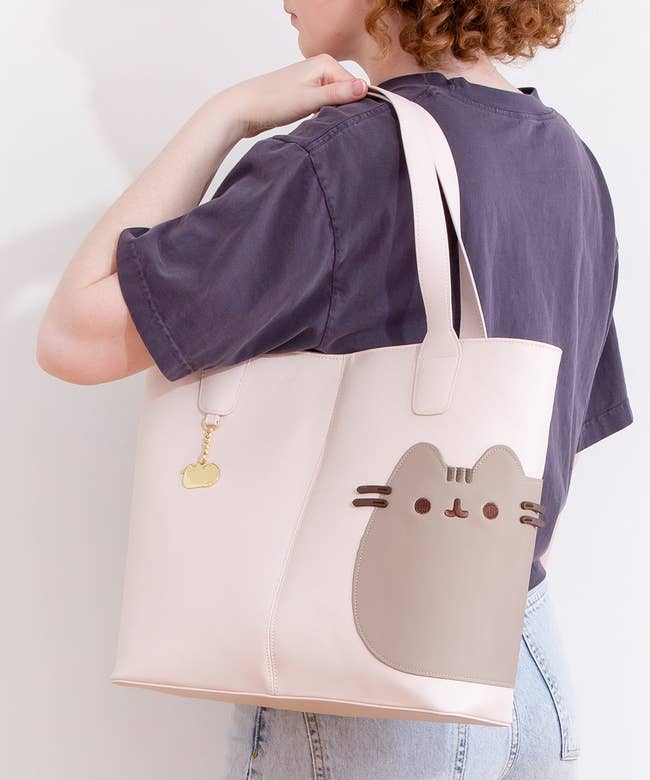 pale pink tote with pusheen with 3d whiskers on it and gold pusheen charm