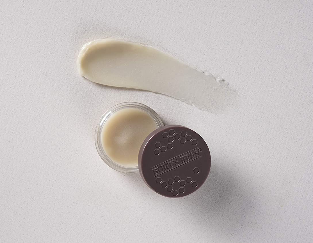 A jar of Burt's Bees overnight lip balm opened with a swatch of the product above the jar