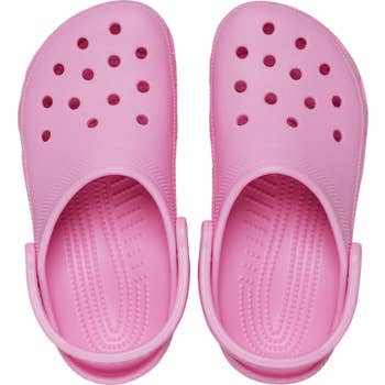 top presumption    of pinkish  Crocs with straps pushed backmost   against a achromatic  background
