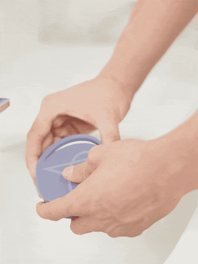 GIF of hand opening and closing portable soap case