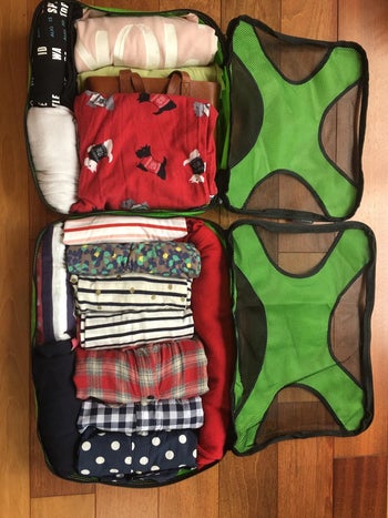 reviewer's clothes neatly organized in green packing cubes