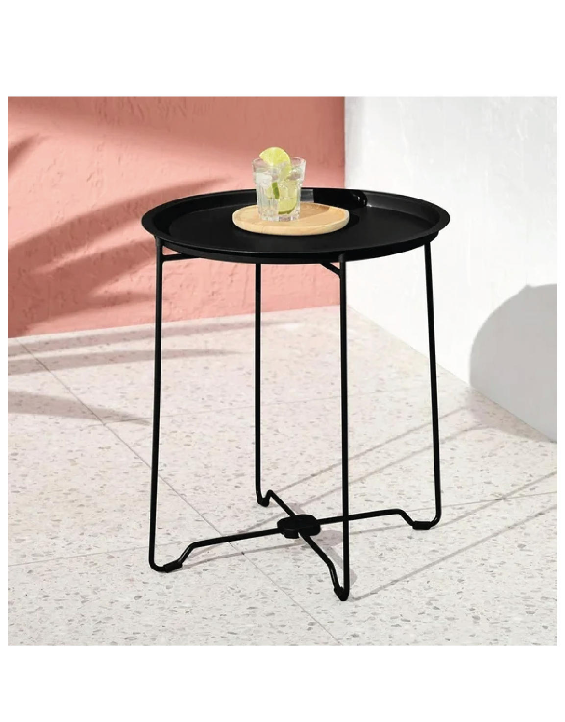 black side table with drink on top 