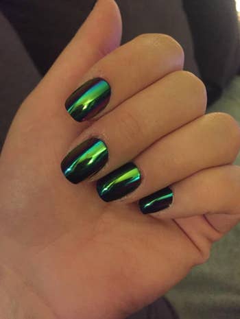 reviewer wearing mid-length holographic green press on nails