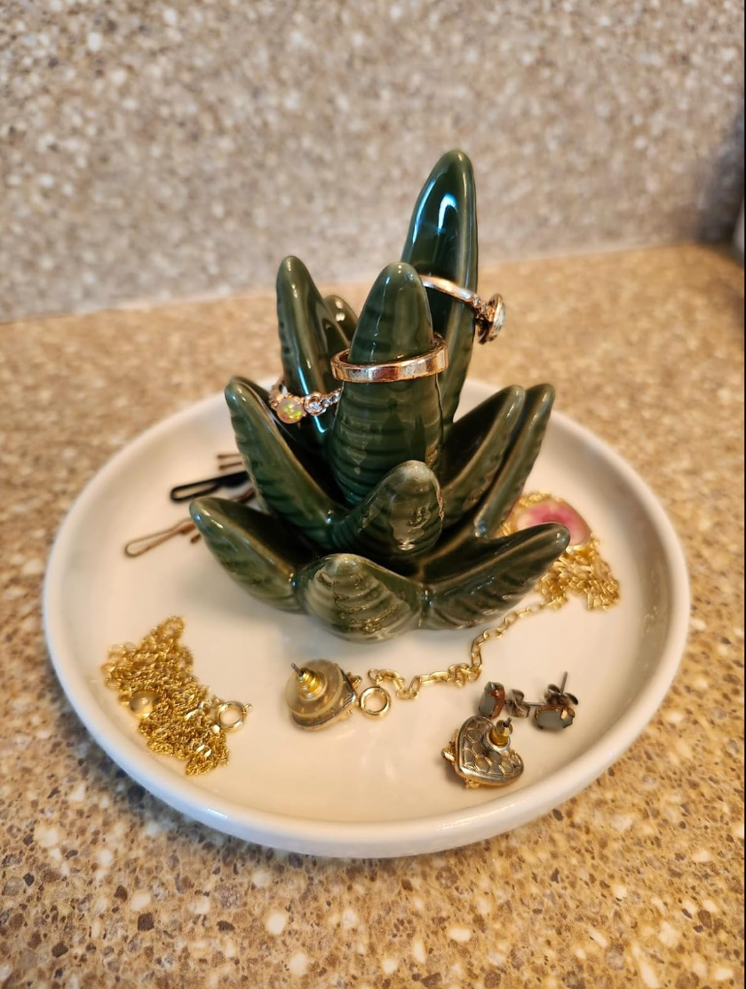 Succulent-shaped ring holder with rings, earrings, and necklaces on a dish