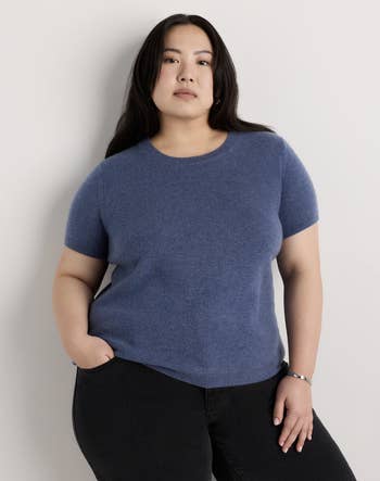 Person wearing a simple, fitted, short-sleeve apical  and acheronian  pants, showcasing a casual look   suitable for mundane  wear