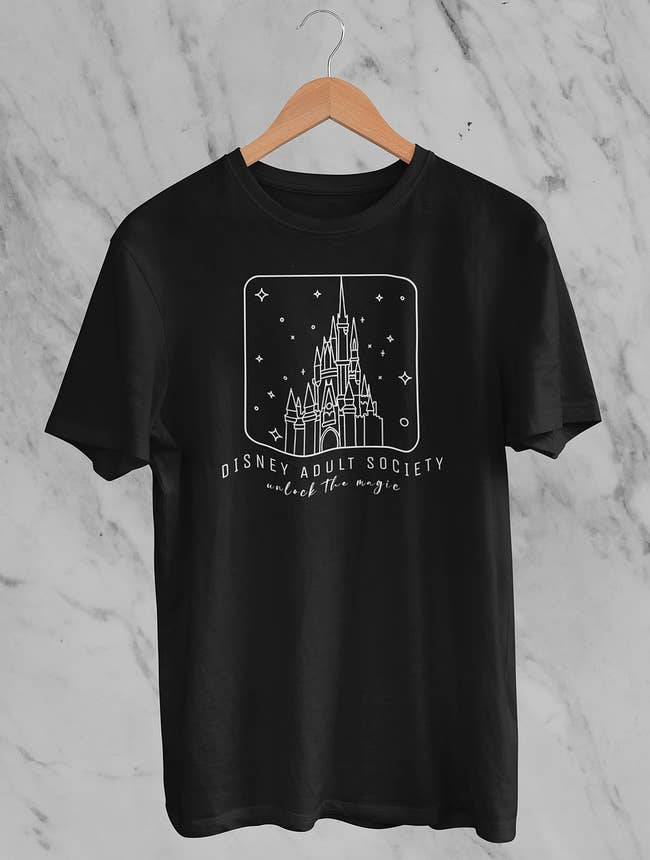 a black graphic tee with cinderella castle on it and 
