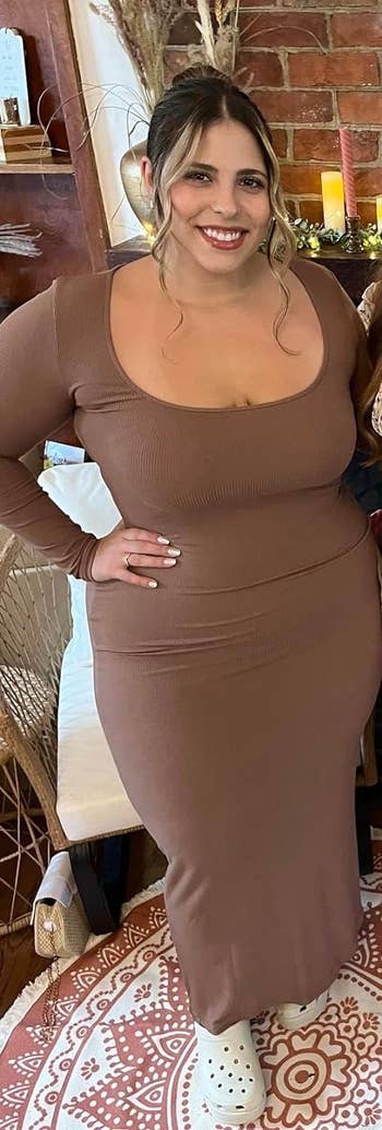 reviewer wearing the dress in brown