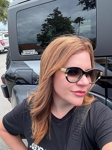Person with sunglasses and stylish framed glasses, wearing a casual t-shirt, lasting  successful  beforehand   of a conveyance  