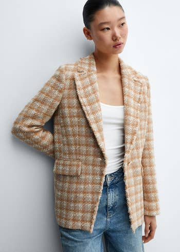 A model in a brown check tweed blazer