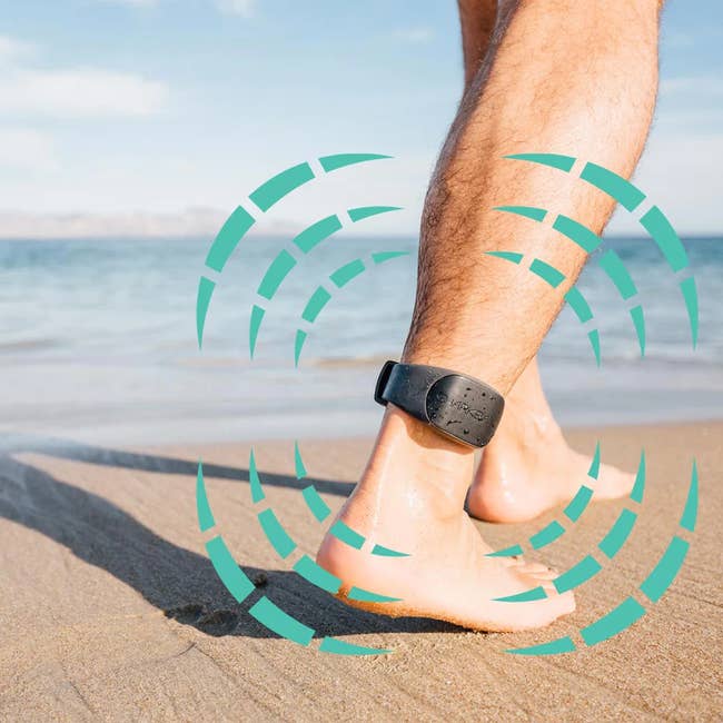 Person at the beach wearing an ankle-worn electronic shark deterrent device