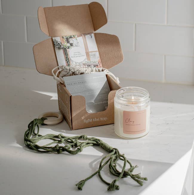 vellabox monthly subscription box with a candle and plant holder