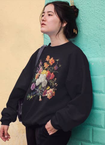 model wearing the black floral sweatshirt