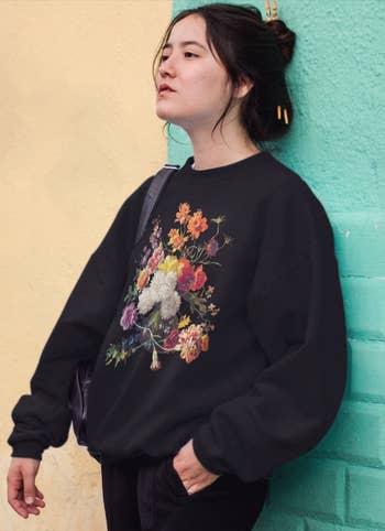 model wearing the black floral sweatshirt