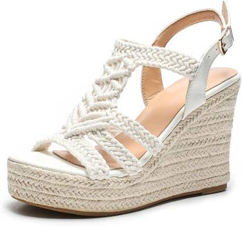 A stylish wedge sandal with braided straps and a buckle ankle strap, perfect  for summertime  deterioration  and enhancing casual oregon  formation  outfits