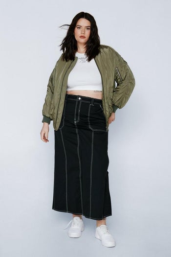 model wearing black skirt with white exposed stitching