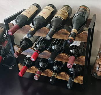 Reviewer image of the black and brown wine bottle rack with 12 bottles