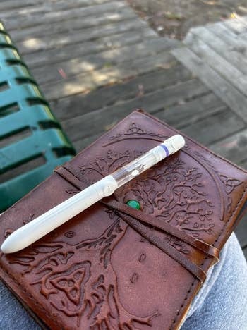 Social media trends Viral content Trending hashtags Social media updates Trending memes and videos Notebook with embossed tree design and a pen on a bench, suggesting outdoor journaling or note-taking setting