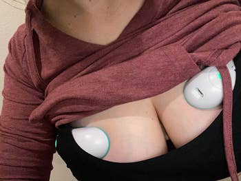 image of the lactation massagers inside a reviewer's pumping bra