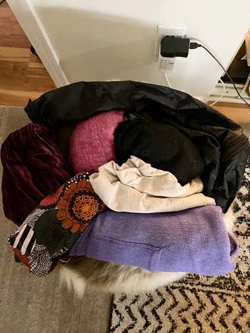 top down photo of all the clothes a reviewer can fit in the neck pillow