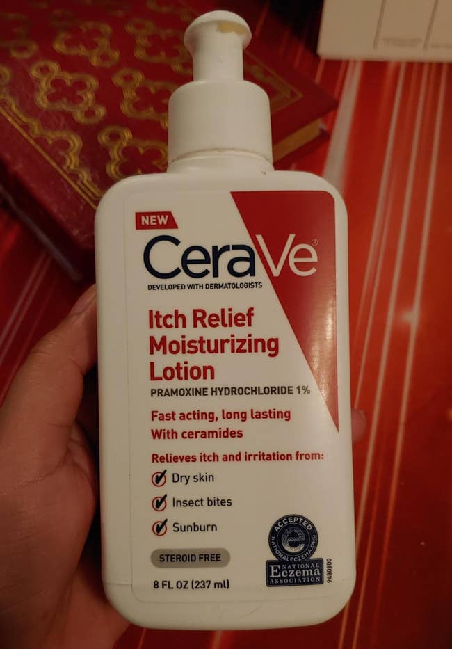 Reviewer holding bottle of CeraVe itch relief lotion