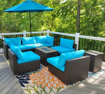 reviewer's outdoor patio furniture set with turquoise sectional and fire pit on a deck